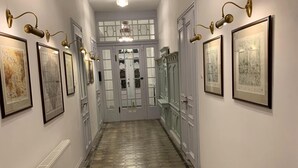 A hallway with patterned flooring, white walls, and framed artwork. - Spacious Holiday Home in Sluknov With Private Garden (Sluknov)
