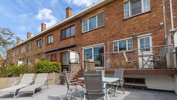 A brick building with a patio area featuring outdoor furniture and a staircase. - Nice Holiday Home in Ostend by the sea With a Terrace (Ostend)