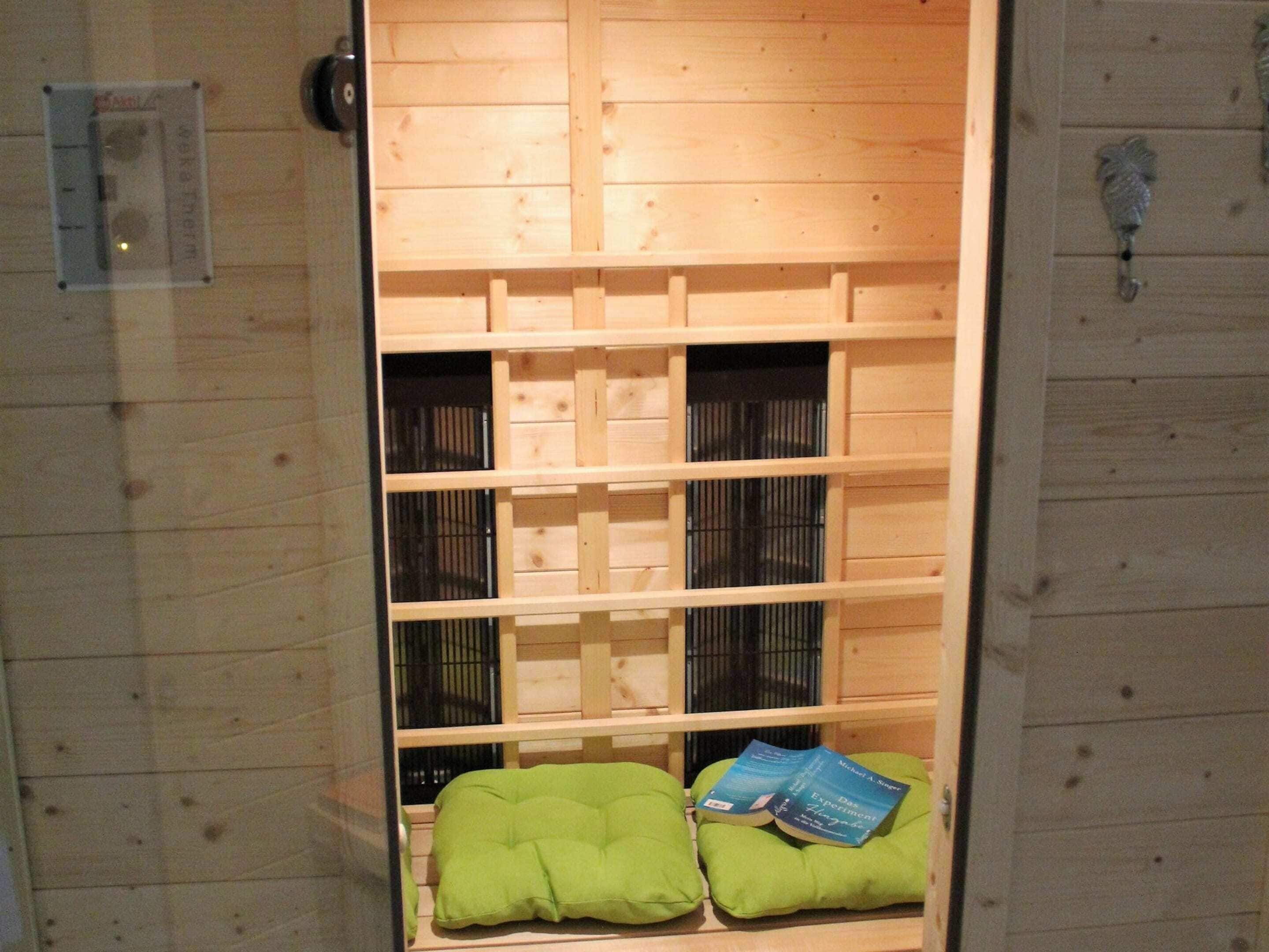 A sauna room with wooden walls and benches.