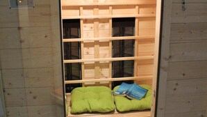 A sauna room with wooden walls and benches. - Apartment in Deudesfeld With Private Terrace (Schutz)