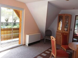 Cozy space with a seating area, cabinet storage, and sliding glass door to a patio.