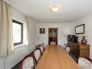 Enjoy meals and meetings in this well-appointed room with a long dining table and comfortable seating.