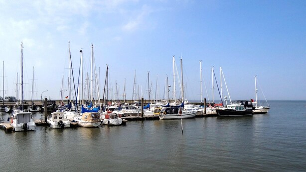 A marina with multiple sailboats docked at the pier. - Nordsee-ferienhaus mit Terrasse (Wangerland)