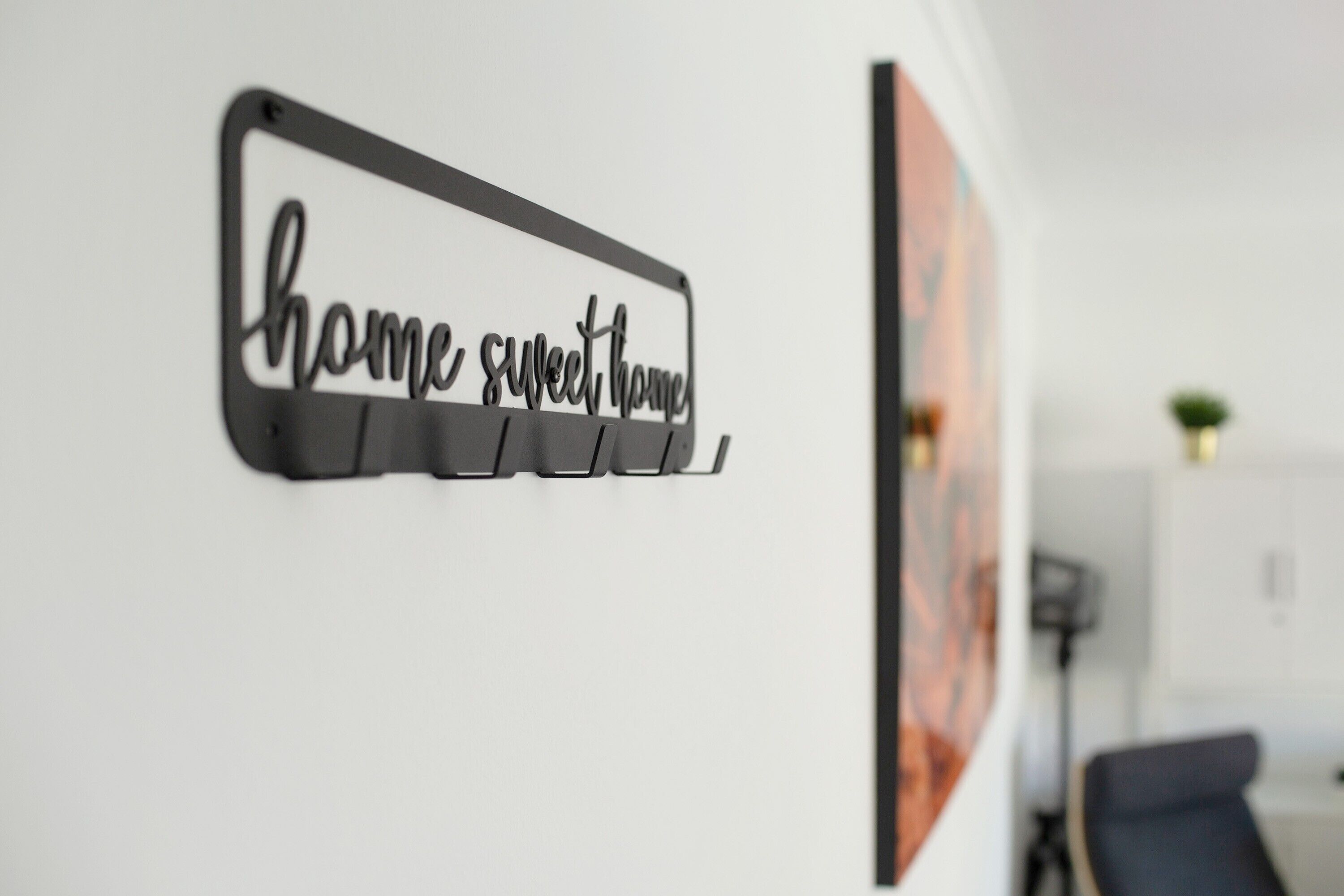 A wall-mounted sign with the text 'home sweet home' in a decorative font.