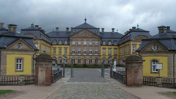 A historic building with a symmetrical facade, large windows, and a central entrance.