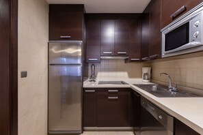 A modern kitchen with stainless steel appliances, a built-in microwave, and a double sink.