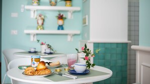 A breakfast table with croissants, a cup, and a jar of jam. - Almare' (Crotone)