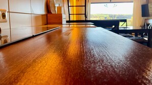 A kitchen with a wooden countertop, white cabinets, and a view of the outdoors. - Ferienhaus, Schontal-winzenhofenn (Schöntal)