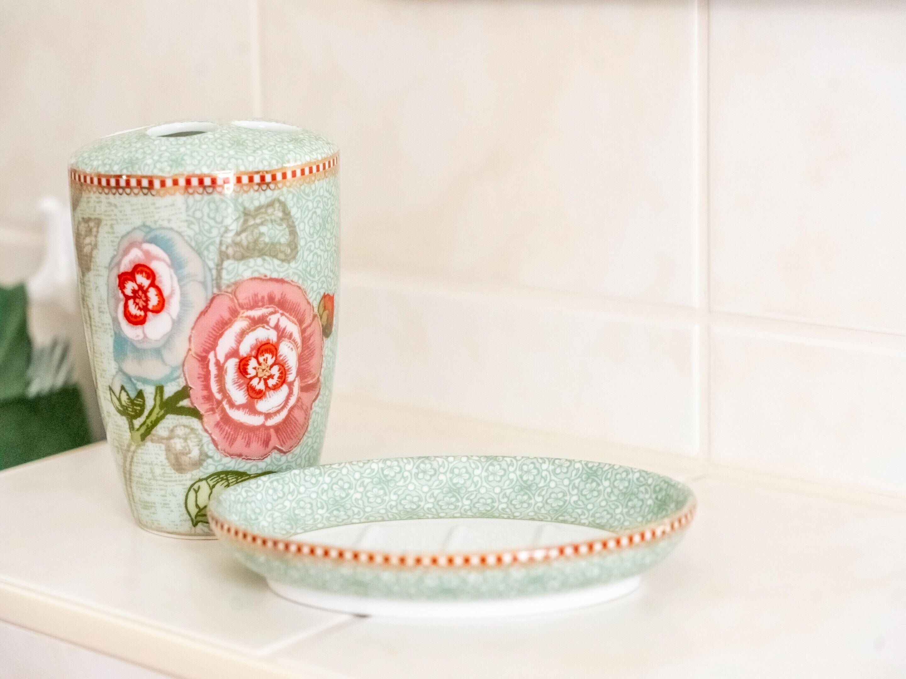 A kitchen with a decorative roll of paper towels and a matching plate.