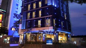 A modern hotel with a prominent "AI HOTEL" sign, multiple floors, and illuminated windows. - AI HOTEL JAKARTA THAMRIN (Jakarta)