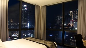 A hotel room with a large window offering a city view at night. - AI HOTEL JAKARTA THAMRIN (Jakarta)