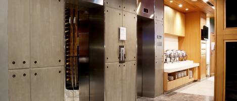 A modern elevator with stainless steel doors and a digital display.