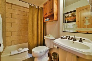 A bathroom with a toilet, sink, and shower curtain. - Beautiful 2 BR Moose Hollow Condo next to Hot Tub (Eden)