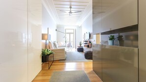 A modern kitchen with a stainless steel refrigerator, a built-in oven, and a microwave. - Modern Chiado by Homing (Lisbon)