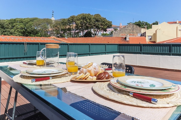 Enjoy breakfast on the outdoor terrace with a view of the surrounding architecture.