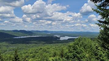 A view of a lake surrounded by forested hills.