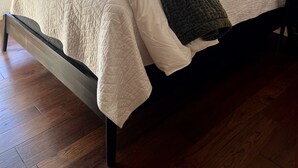 A bed with a quilted white and green blanket, wooden headboard, and a ceiling fan. - NEW ADIRONDACK LUXURY CABIN WITH YEAR-ROUND HEATED PLUNGE POOL (Old Forge)