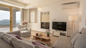 A modern living room with a sofa, a coffee table, a TV, and a lamp.