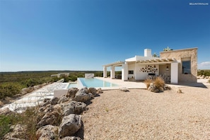 A modern house with a pool, stone walls, and a clear view of the landscape. - 246 Villa Extralusso con Piscina a Manduria (Manduria)