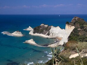 A coastal landscape with cliffs and a beach. - Amazing Apartment in Mpenitses With Terrace (Corfu)