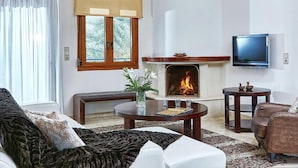 A living room with a fireplace, a television, and a sofa. - Fantastic Holiday Home in Karteros With Pool (Hersonissos)