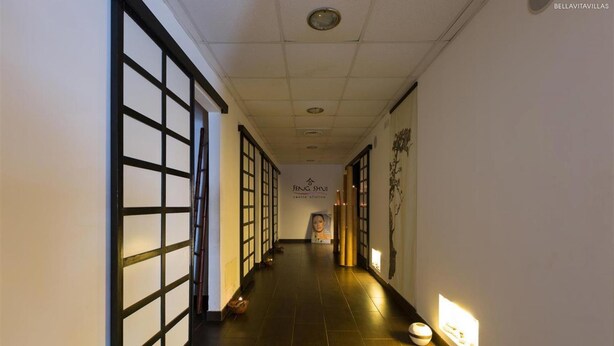 A hallway with traditional sliding doors, a sign for Feng Shui center, and a wall-mounted light fixture. - 1742 Silver Hotel - Le Triple (Matino)