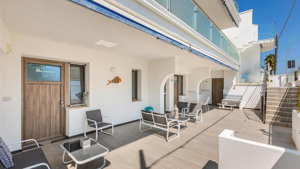 A modern outdoor area with seating and a staircase. - 2133 Maresidence - Camere Matrimoniali (Salve)