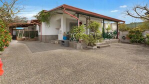 A two-story house with a covered porch, a gravel driveway, and potted plants. - 2338 Bilo Imma B by Barbarhouse (Porto Cesareo)