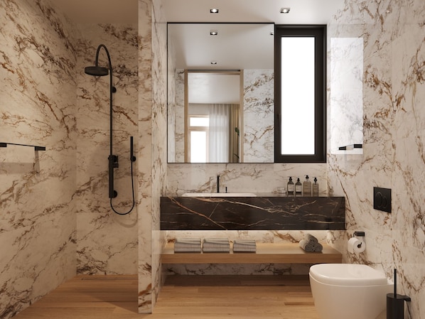 A modern bathroom with marble walls, a black marble countertop, a wooden shelf, a white toilet, and a shower with a black hose. - The 12th City Hotel  (Rhodes)