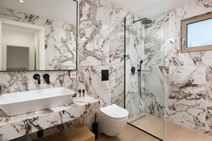 Family Apartment | Bathroom | Rainfall showerhead, hair dryer, bathrobes, slippers