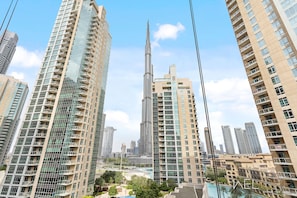 A high-rise building with a prominent central tower, surrounded by other tall residential buildings.