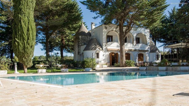 A large, white, castle-like building with a swimming pool in front. - 751 Trullo con Piscina e Pineta a Locorotondo (Locorotondo)