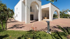 A modern building with a courtyard, featuring a central open space with seating and a small pool. - 1609 Villa Emary in San Vito dei Normanni (San Vito dei Normanni)