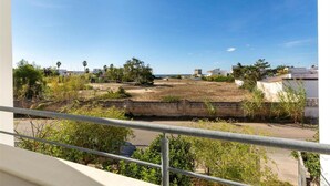 A view of a residential area with a clear sky, a fenced yard, and some vegetation. - 2091 Villino Tropical (Porto Cesareo)