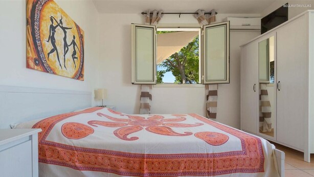 A bedroom with a bed, a large mirror, and a painting on the wall. - 2028 Soledelsud - Monolocale by Barbarhouse (Otranto)
