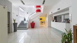 A modern hotel lobby with a staircase, a reception desk, and a dining area. - 1745 Silver Hotel - Matrimoniale (Matino)
