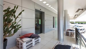 A modern interior with a large plant, wooden pallets, and a view of the outside. - 1745 Silver Hotel - Matrimoniale (Matino)
