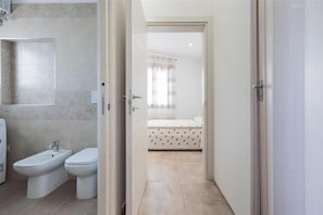 A bathroom with a bidet, toilet, and a mirror. - 2300 Villino Vanessa (Porto Cesareo)