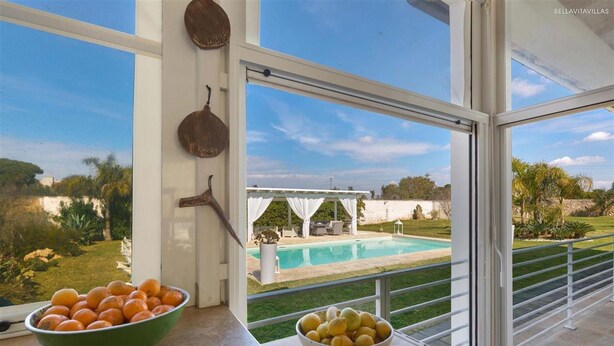 A view from a balcony with a pool, a green bowl of oranges, and a white bowl of lemons. - 2248 Villa Padangi in Gallipoli (Gallipoli)
