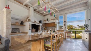A spacious kitchen with a large wooden table, wooden chairs, and a view of the outdoors. - 2248 Villa Padangi in Gallipoli (Gallipoli)