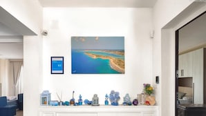 A hotel room with a white console table, a framed picture of a coastal landscape, and a rating sign. - 1283 B B Dreams and Delights - Sea Sight Camera Familiare (Porto Cesareo)