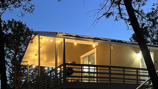 A two-story house with a balcony and a staircase leading to the upper level. - Amazing Views - Peaceful surroundings - Pets OK with fee (Ruidoso)
