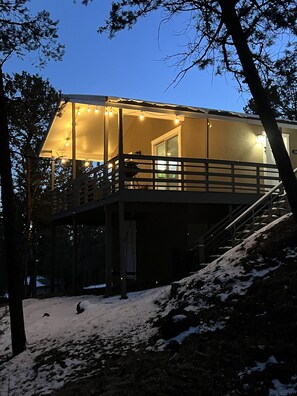 Una casa a due piani con un balcone e una scala che conduce al piano superiore.