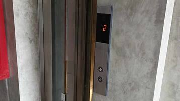 An elevator interior with a digital display showing the number 2.