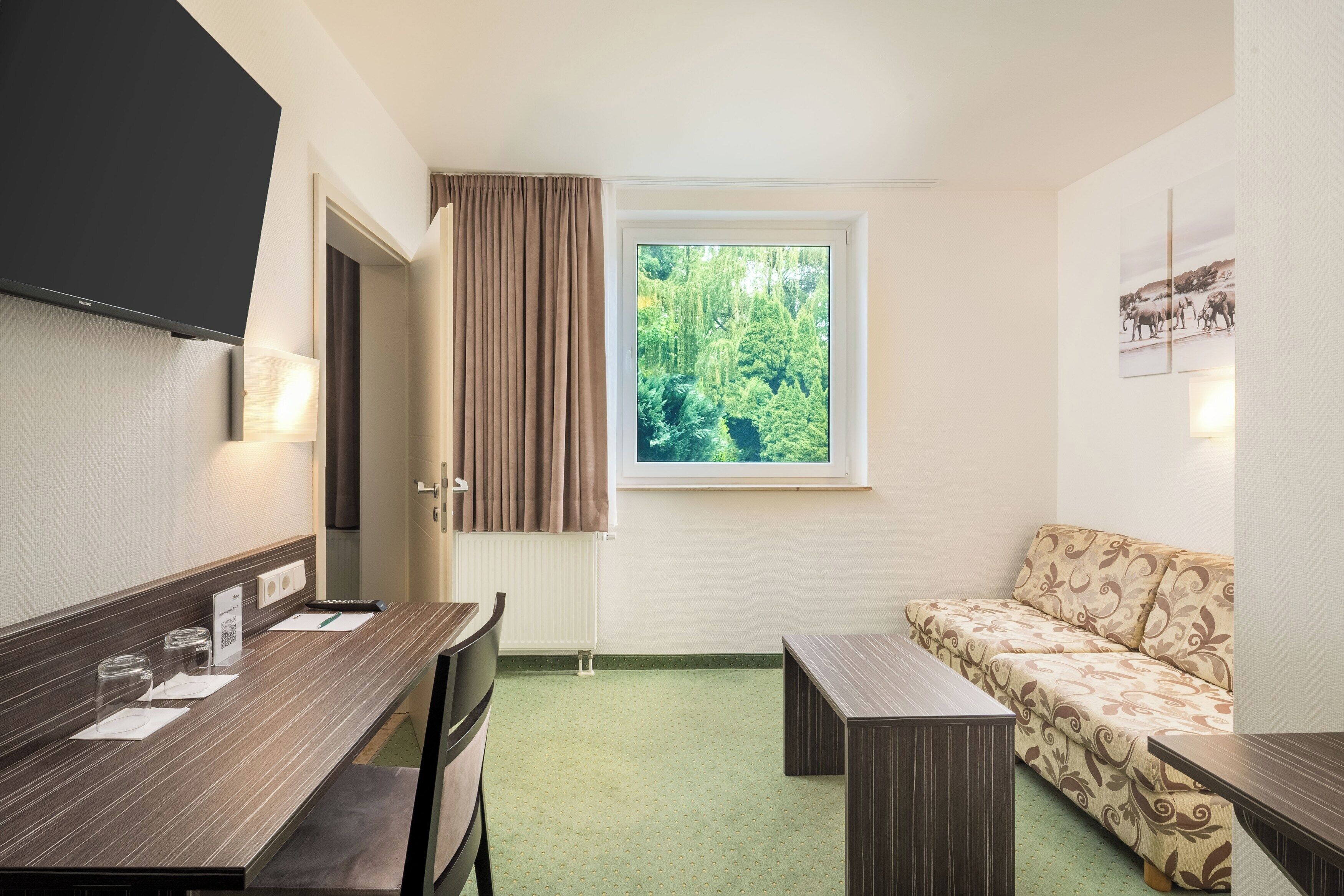 Junior Suite | Living area | 30-inch flat-screen TV with cable channels, TV