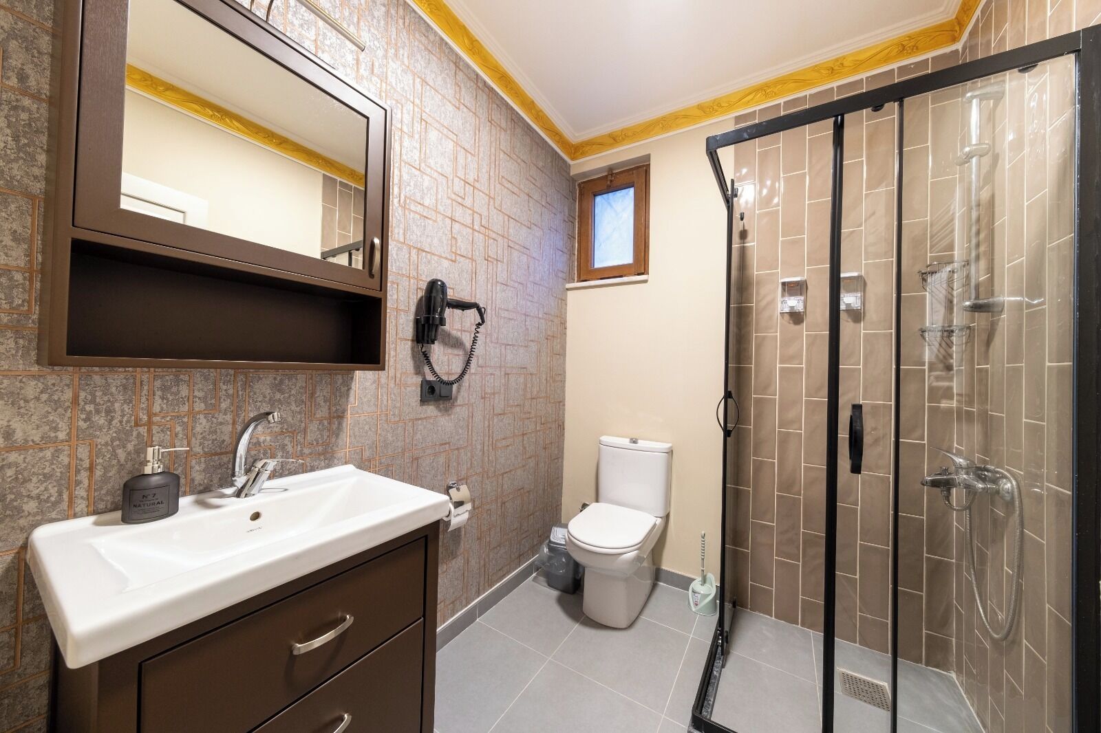 A bathroom with a sink, toilet, and walk-in shower.