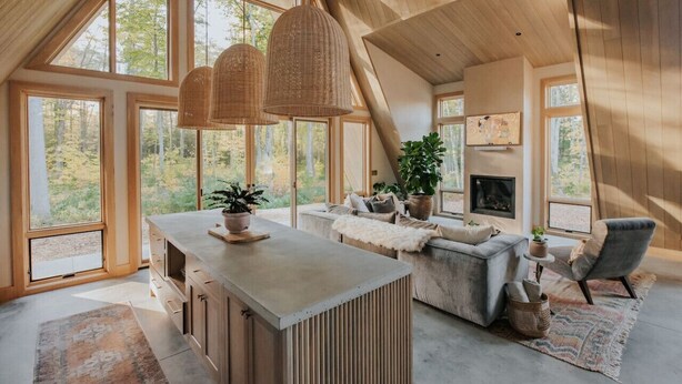 A spacious loft with large windows, a fireplace, and a cozy seating area. - *NEW* Luxury A-Frame by Sunday River w/ hot tub (Bethel)