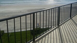 A balcony with a view of a beach and ocean. - Fantastic and completely updated direct ocean front condo at the Caribbean (Daytona Beach Shores)