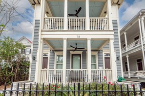 A two-story house with a balcony, a number '78' on the front, and a 'FDC' sign on the door.
