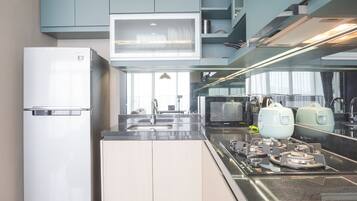 Deluxe appartement | Privékeuken | Een koelkast/vriezer, een kookplaat, een rijstkoker